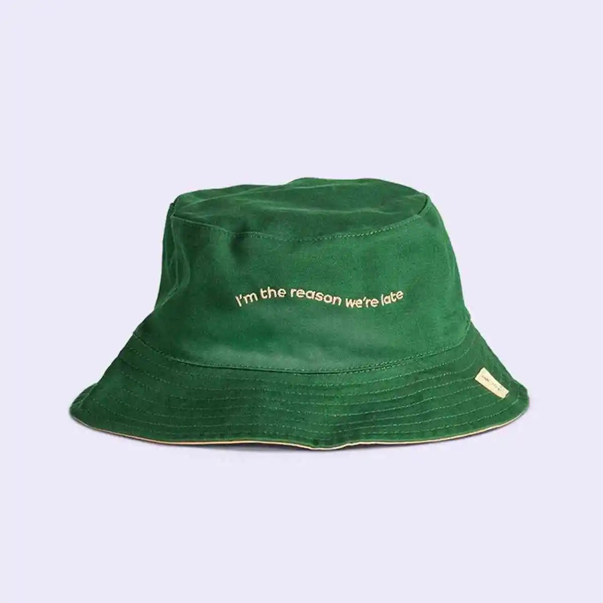 Green bucket hat with text on a light purple background
