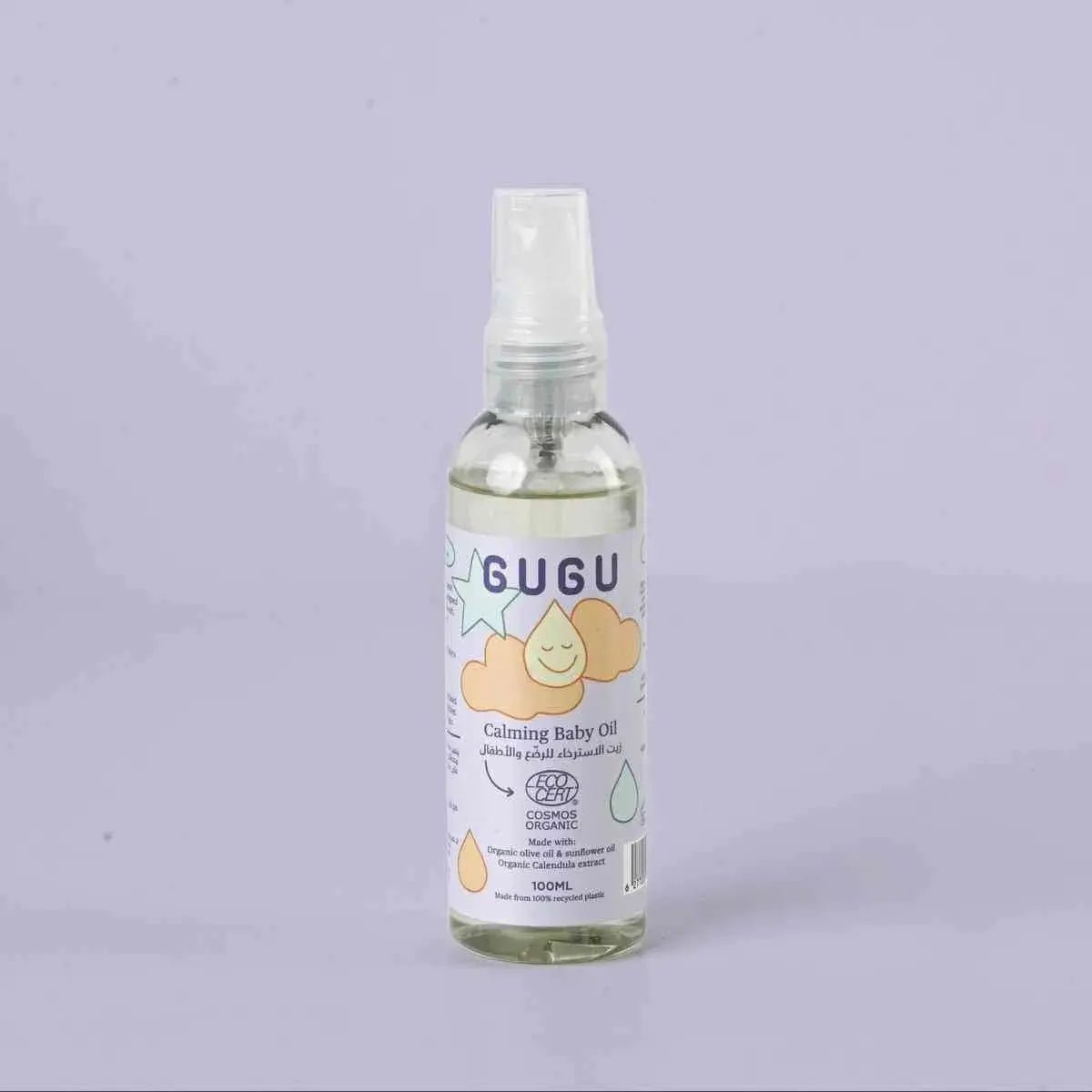 Bottle of GUGU calming baby oil on a light purple background
