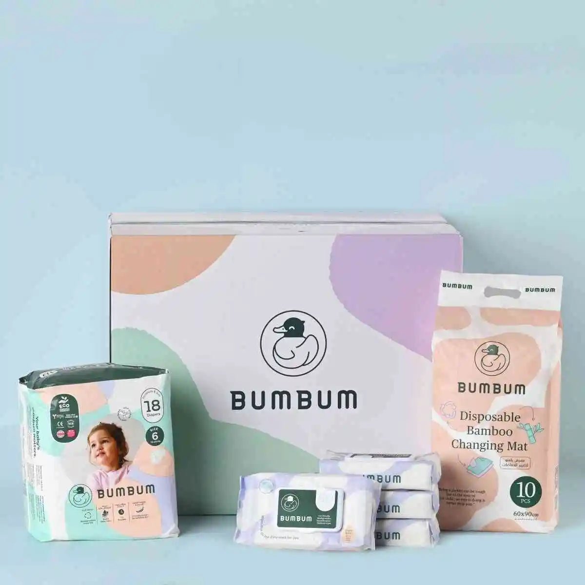 Bumbum baby product set including diapers, wipes, and changing mat on a light blue background